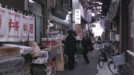 People-shopping-in-side-street-in-Tokyo,-Japan