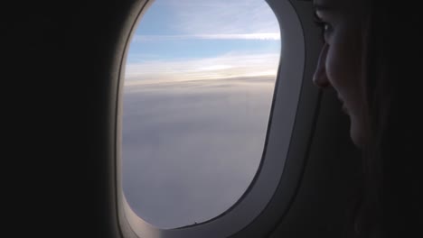 Girl-looks-out-of-the-aeroplane-window