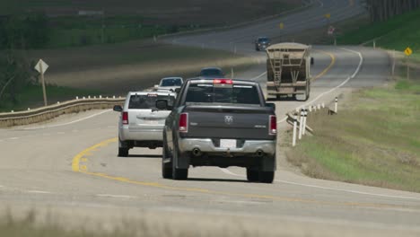 Various-vehicles-drive-by-on-highway-near-Dunvegan-Alberta