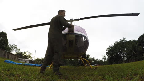 Low-angle-shot-as-a-pilot-checking-the-helicopter,-preflight-preparation-procedure-for-safety