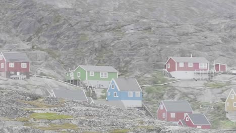 Sailing-Past-Colourful-Houses-On-Rocky-Hill-In-Greenland