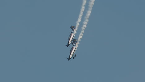 Close-up-of-F1-Rocket-and-Harmon-Rocket-II-airplanes-diving-and-pulling-out-of-dive-with-smoke-trails-at-airshow-in-slow-motion