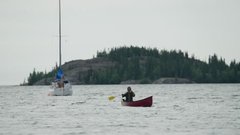 Man-paddling-canoe-across-harbor