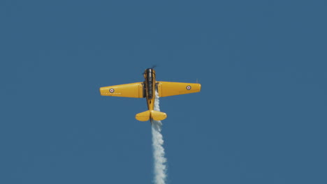 Close-up-of-North-American-Harvard-Mark-IV-airplane-in-steep-vertical-climb-at-airshow-in-slow-motion