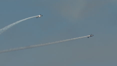Die-Stuntflugzeuge-F1-Rocket-Und-Harmon-Rocket-II-Führen-Bei-Einer-Flugshow-Kunstflug-Fassrollen-Mit-Rauch-In-Zeitlupe-Durch