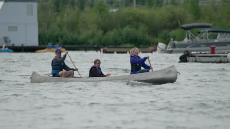 Family-paddle-canoe-across-harbor