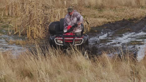 ATV-rider-stuck-in-mud-tries-to-get-out