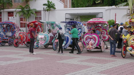 Beautiful-vibrant-scene-of-decorated-trishaws-parked-as-tourists-walk-by