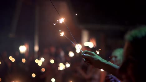 A-line-of-sparklers-being-held-up-at-a-wedding