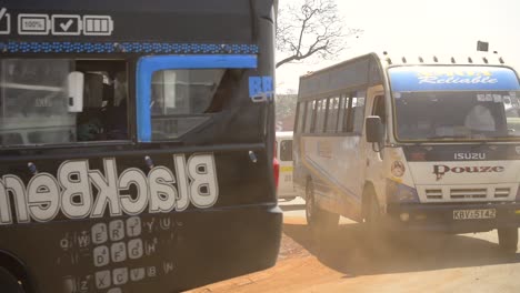 Public-buses-drive-through-Nairobi's-city-center-in-Kenya,-East-Africa