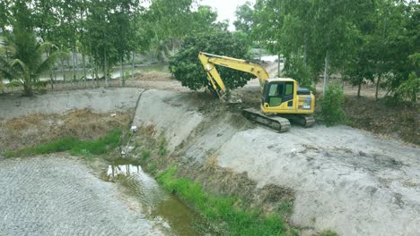 Aerial-drone-view-of-backhoe-machinery-digging-the-soil-to-make-the-pool-storage