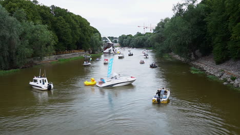 Timelapse-of-a-numerous-boats-sailing-on-river-Emajogi-in-Tartu-city,-Estonia
