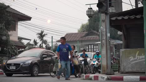 Man-walking-over-busy-street-in-Asia