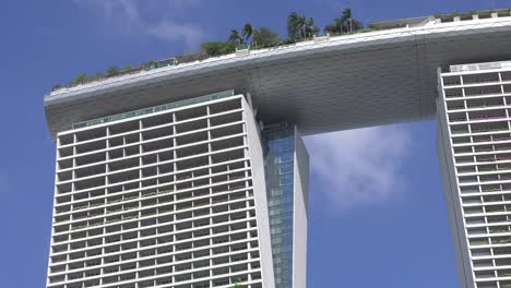 Looking-Up-At-Marina-Bay-Sands-Hotel-Against-Blue-Skies-In-Singapore