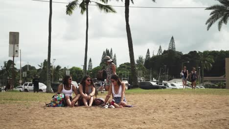 Young-teenage-Girls-hanging-out-by-the-beach-in-Oahu-Island,-Hawaii---Wide-shot