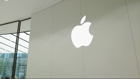 Apple-store-in-Dubai-Mall-in-September-2020-day-time-view-from-big-Apple-logo-on-wall-and-pan-left-to-the-people-wearing-face-mask-inside-the-store
