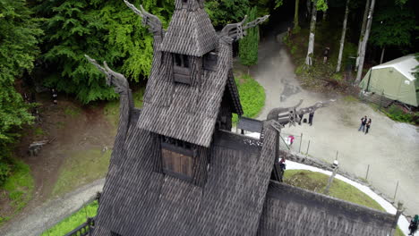 Drone-shot-close-to-details-on-a-medieval-stave-church-in-sunny-Fantoft,-Norway
