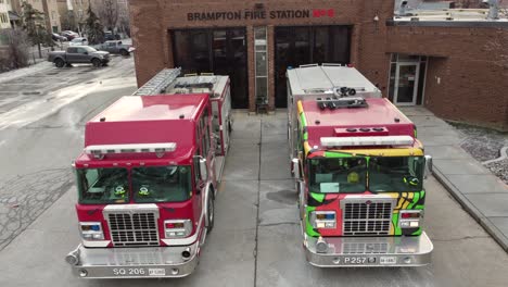 Black-history-month-firetruck-at-Brampton,-Canada-station-in-winter,-aerial-dolly
