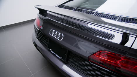 Carbon-Fiber-Rear-Wing-And-Chrome-Emblem-Of-Audi-R8-V10-Performance-Supercar-In-Showroom