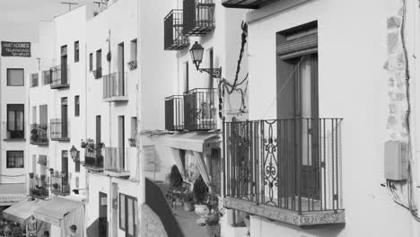 Black-and-white-shot-of-typical-buildings-in-historic-town-center-of-Peniscola,-Valencia-in-Spain-at-daytime