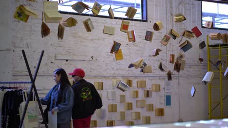 Tourists-visiting-and-Harry-Potter-exhibition-with-Hang-books-at-Bio-bio-market,-Santiago-de-Chile