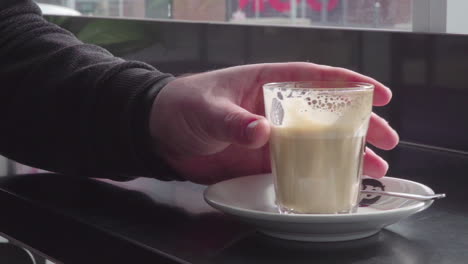 Slow-motion-shot,-the-coffee-is-gently-lifted-from-the-table