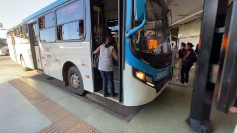 A-view-of-a-bus-station-while-a-passenger-is-getting-into-the-bus