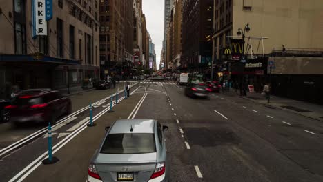timelapse-and-motionlapse-from-8th-Ave,-New-York,-daytime-with-people-and-vehicles-moving-inside-the-city-of-manhattan-with-skyscrapers-in-background
