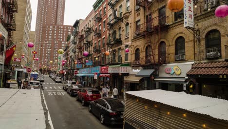 timelapse-and-motionlapse-of-Chinatown-by-day-with-Chinese-decoration-and-stores-while-people-and-vehicles-pass-by