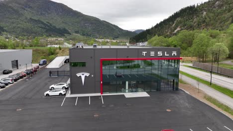 Building-of-Tesla-car-dealership-in-Forde-Norway---Modern-designed-building-backward-moving-aerial