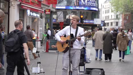 Young-Male-Street-Performer-Playing-Guitar-in-London-Chinatown