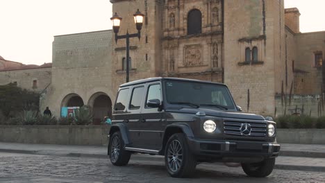 Exclusive-black-G-class-Mercedes-Benz-parked-in-middle-of-the-street-at-sunset