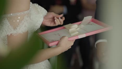 Bride-signing-wedding-certificate-during-wedding-ceremony