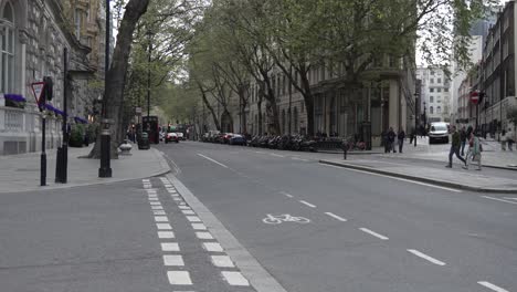 Street-Level-Shot-of-Cars-and-Pedestrians-on-London-Streets