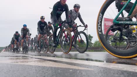 Professional-group-of-cyclists-cycling-during-famous-Giro-d'Italia-race-stage-in-Italy