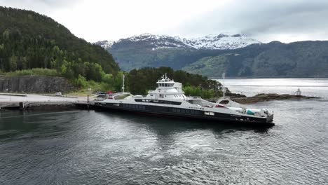 Electric-ferry-Gloppefjord-alongside-Anda-ferry-pier-for-loading-cars-and-charging-batteries---Electric-ferry-from-Fjord-1-company---Aerial-view