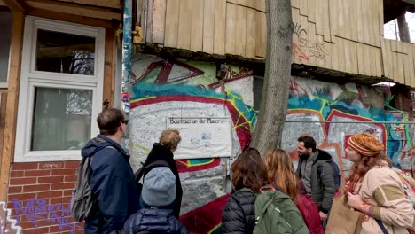 Tour-Guide-Explaining-History-Behind-Baumhaus-an-der-Mauer-Tree-House-In-Berlin