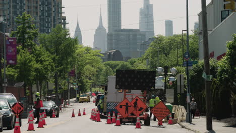 Road-Construction-On-Queens-NYC-Street-With-Manhattan-Skyscrapers-In-Distance