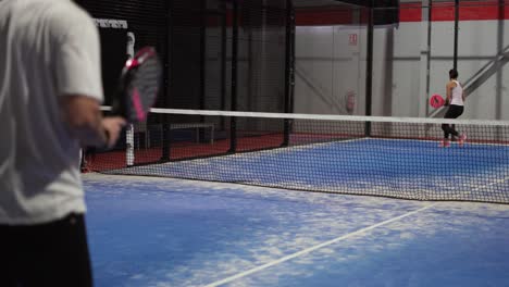 Murcia,-Spain,-May-23,-2023:-Young-sportswoman-and-man-couple-playing-padel-tennis-in-slow-motion