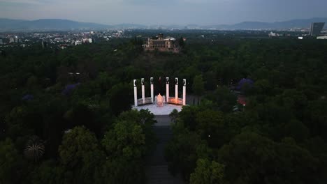 Aerial-view-over-the-park,-Altar-a-la-Patria-and-the-Chapultepec-Castle,-sunset-in-Mexico-city