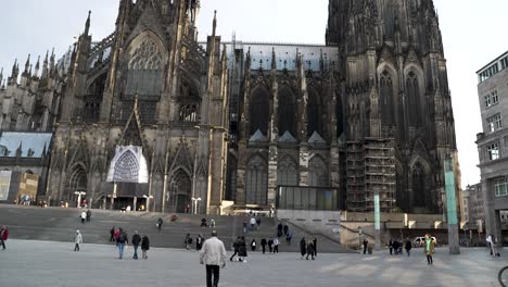 Cologne,-Germany---Tilt-up-shot-of-locals-and-tourists-walking-around-Cologne-Cathedral-in-front-of-the-Central-Station-at-daytime
