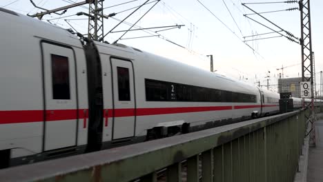 Watching-DB-High-Speed-ICE-Train-Going-Past-On-Hohenzollern-Bridge-Over-Railing