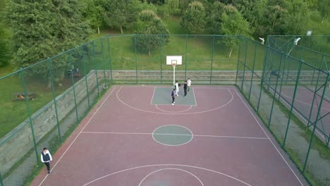 Drone-footage-of-children-playing-on-the-basketball-court