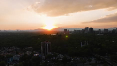Aerial-view-approaching-the-Chapultepec-Castle,-colorful-sunset-in-Mexico-city