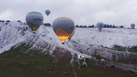 Hot-air-balloon-scenic-flight-over-travertine-mineral-waters-of-Pamukkale