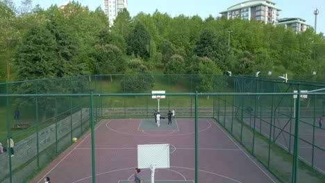Drone-footage-of-children-playing-on-the-basketball-court