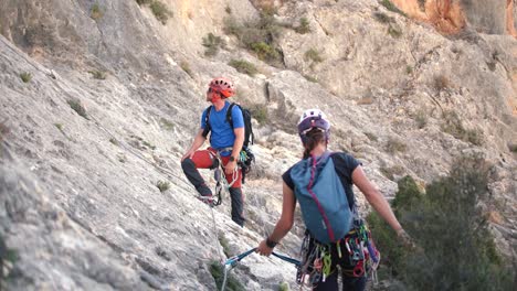 Murcia,-Spain,-May-20,-2023:-Via-ferrata-ascension-by-group-of-sportsmen-drone-aerial-view-of-mountain-and-mountaineers-climbing-in-Alicante,-Spain