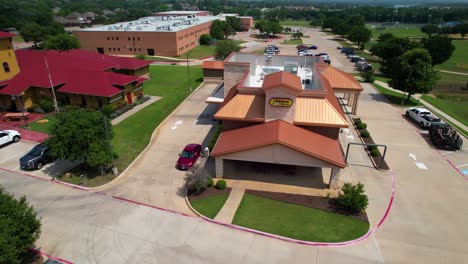 This-is-editorial-aerial-footage-of-Chicken-Express-in-Highland-Village-Texas-located-at-2450-Justin-Rd,-Highland-Village,-TX-75077