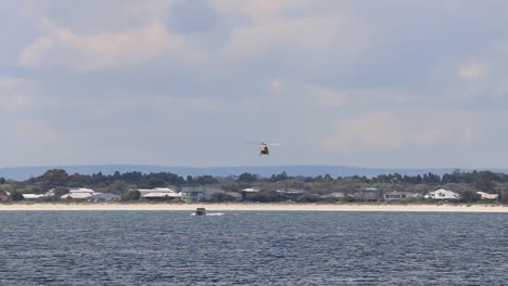 Rescue-Helicopter-Tracking-Coastguard-Boat-During-Training-Exercises,-Busselton,-Australia