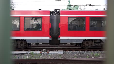 Slow-motion-shot-of-passenger-coaches-of-a-train-in-Cologne,-Germany-at-daytime